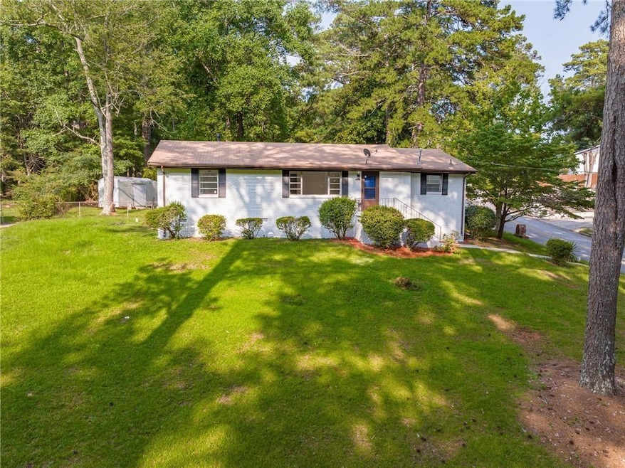 View of front of home with a front yard and stucco siding