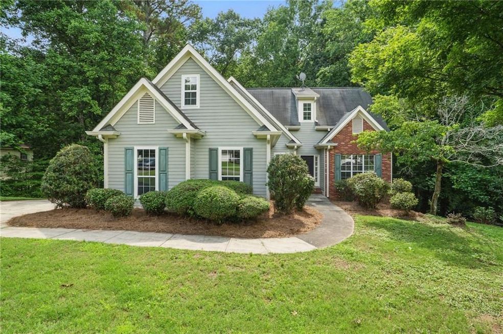 Traditional-style house featuring a front lawn and brick siding