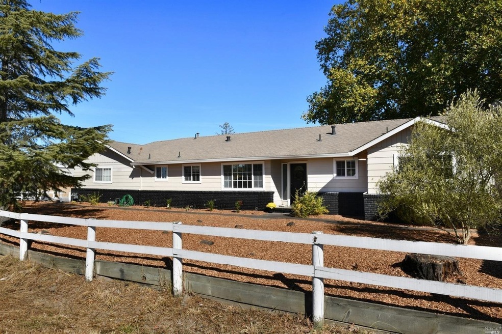 Gracious front yard with quaint white decorative f