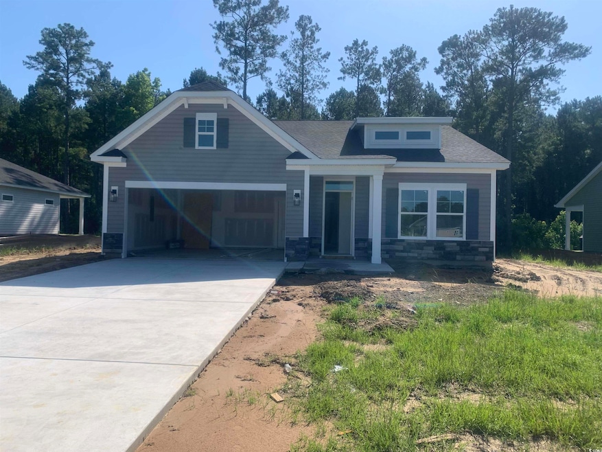 Craftsman inspired home featuring concrete driveway, stone siding, an attached garage, and a shingled roof