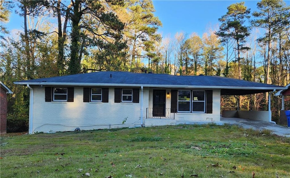 Ranch-style home featuring a carport and a front l