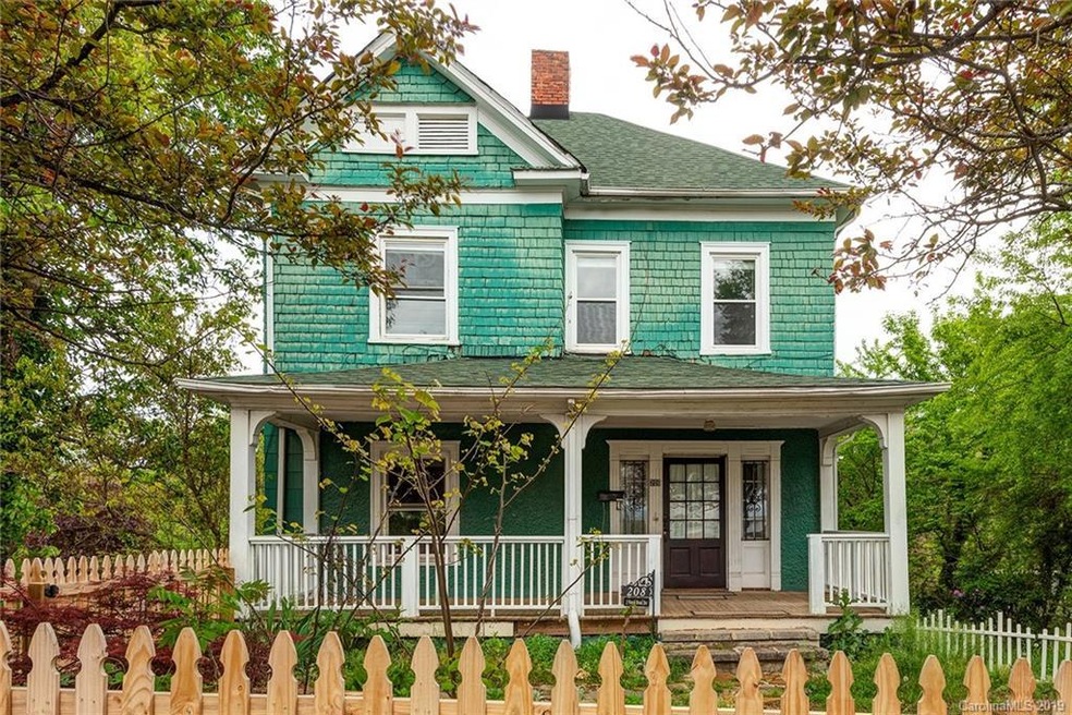 Classic Downtown Asheville Arts and Crafts construction from 1910, with stately front porch facing Asheville Middle School and ridge views in the distance.