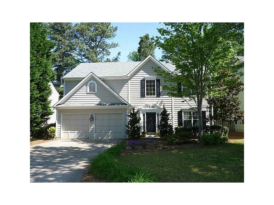 Exterior Front. Beautifully landscaped yard with f