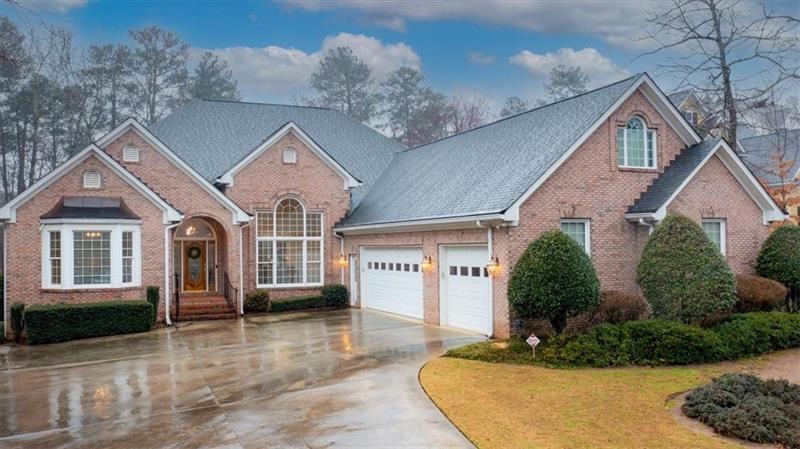 front of home.  4 sides brick, 3 car garage, level