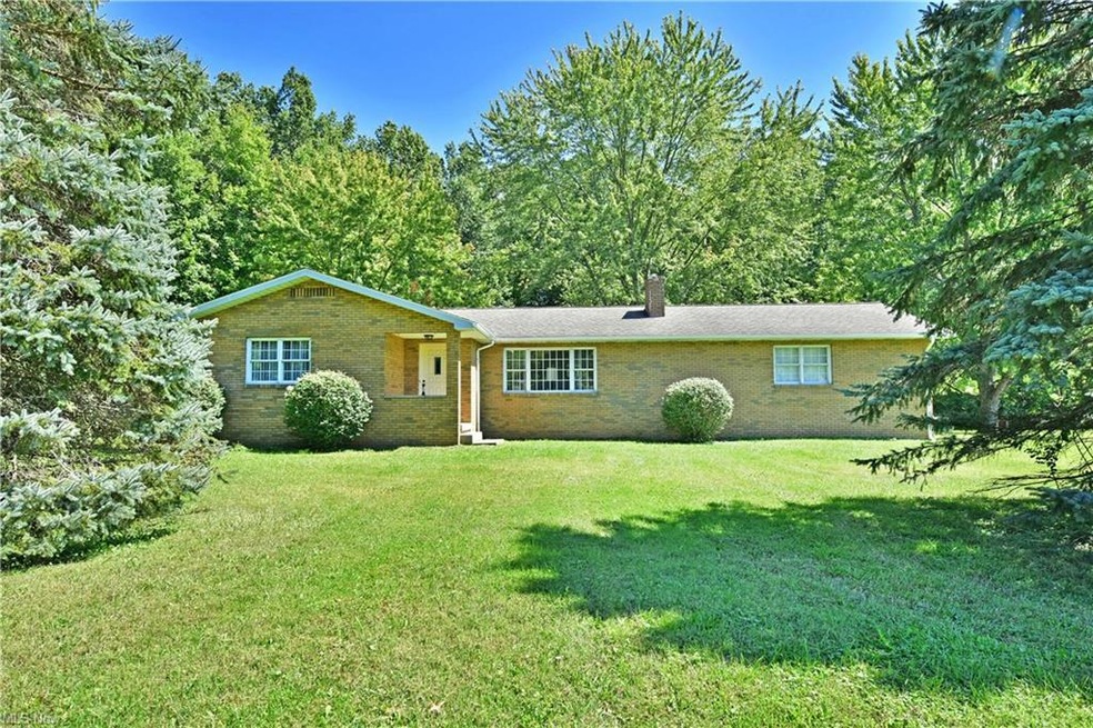Single story home with a front lawn