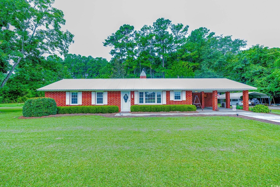 Ranch-style house featuring a carport and a front 