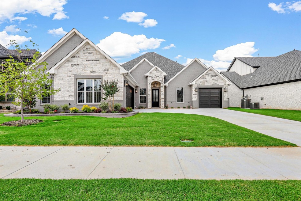 View of front facade with a front yard, a garage, 