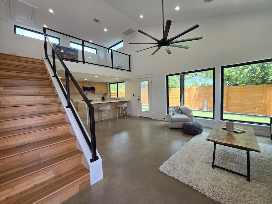 Living area with finished concrete flooring, rece