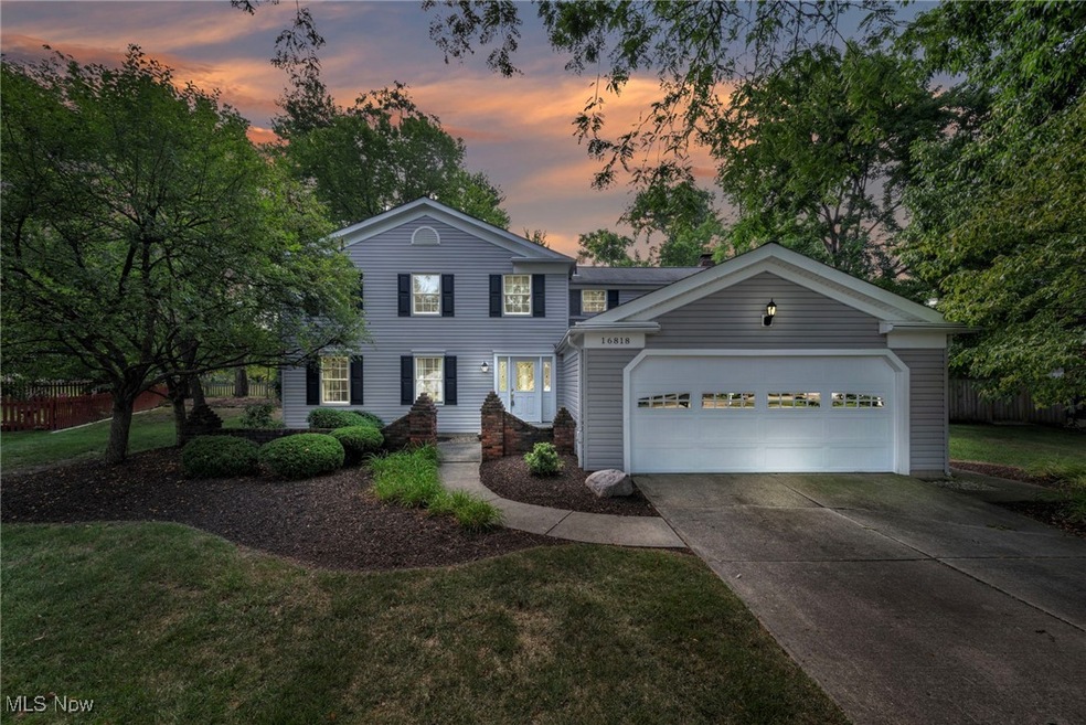 View of front of home featuring a garage and a lawn