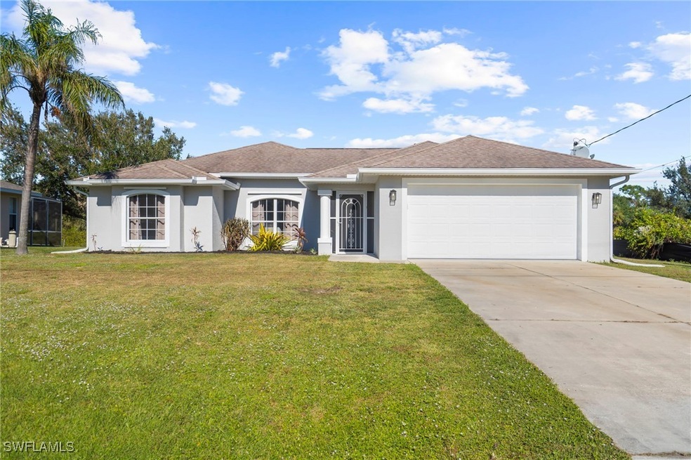 Ranch-style house featuring a garage and a front y