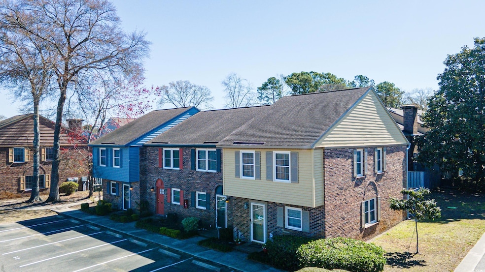 View of front of property featuring a chimney, roo