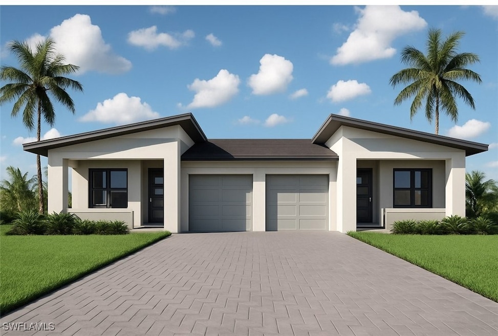 View of front of home featuring stucco siding, an