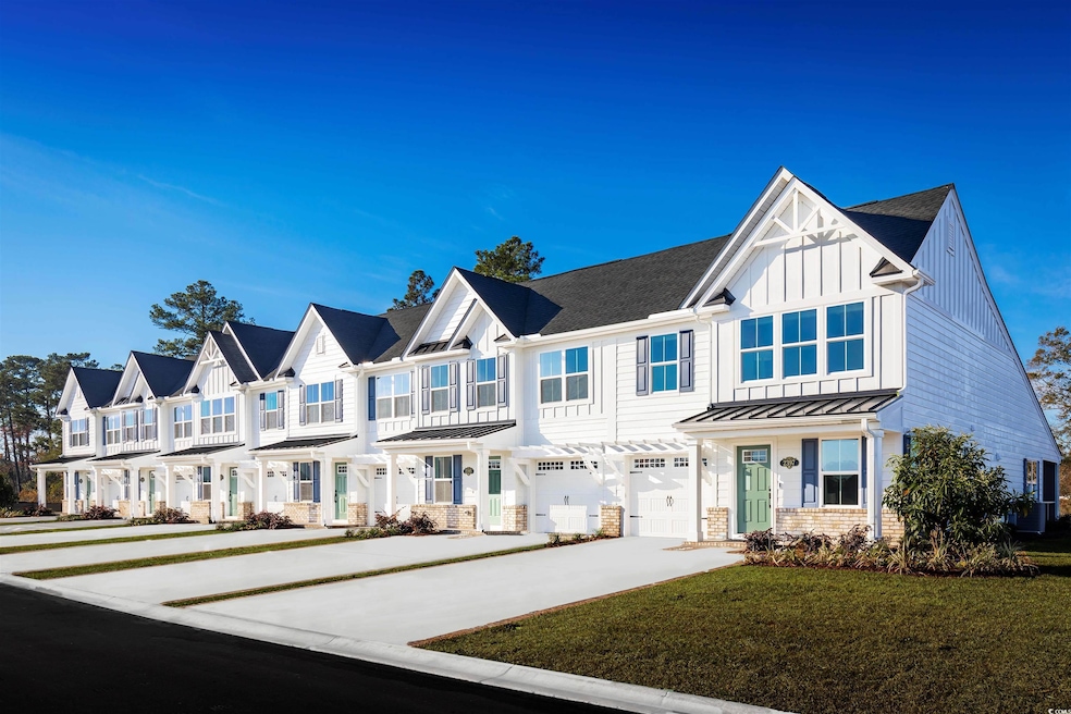Townhome / multi-family property featuring a front