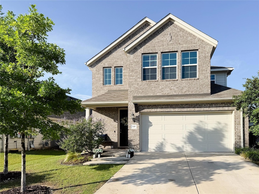 View of front of property with driveway, brick si