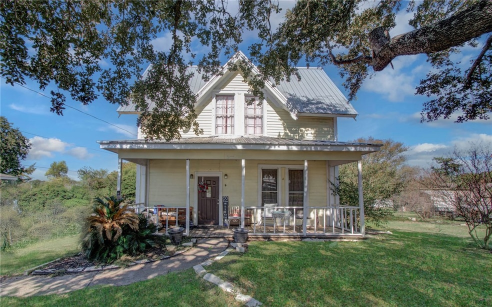 View of front of home with covered porch and a fro