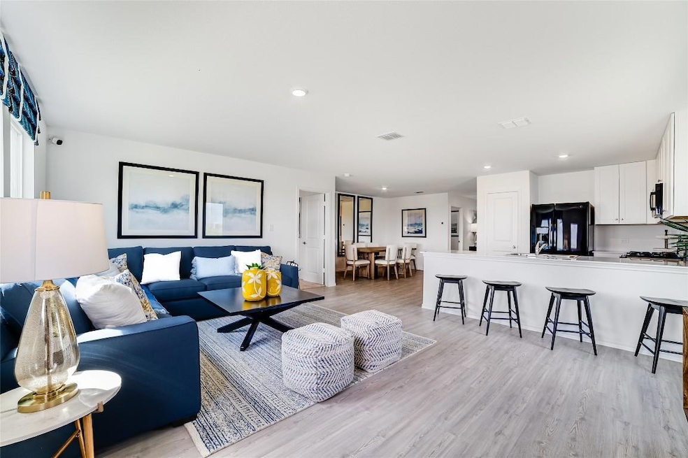 Living room with light wood finished floors and r