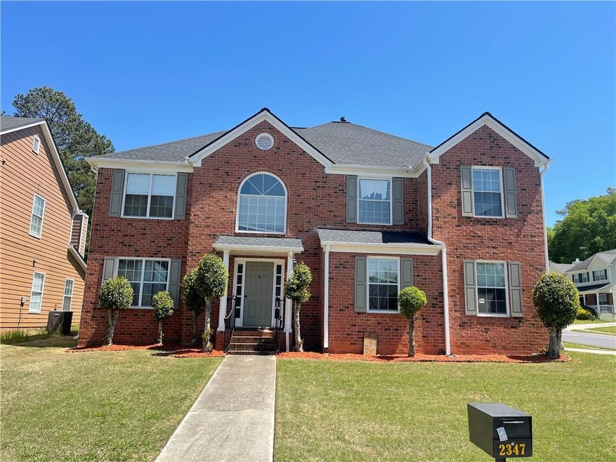 View of front facade with a front yard and brick s