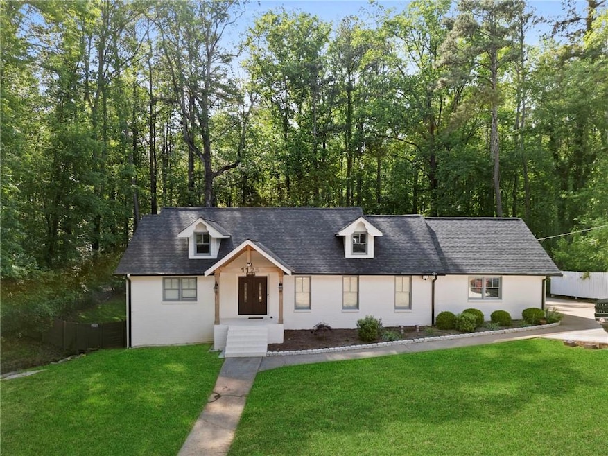 View of front of house with a shingled roof, a fro