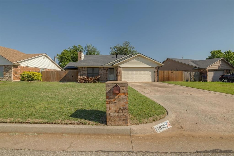 Ranch-style house with a garage, driveway, a chimn