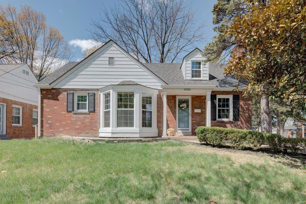 Front Elevation - Covered front porch, 4 sides bri