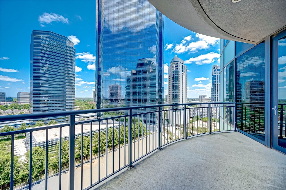 Spacious balcony with stunning cityscape views, surrounded by modern high-rise buildings, perfect for urban living.