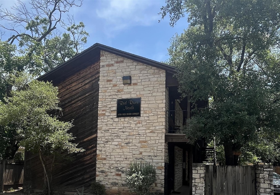View of side of property featuring stone siding
