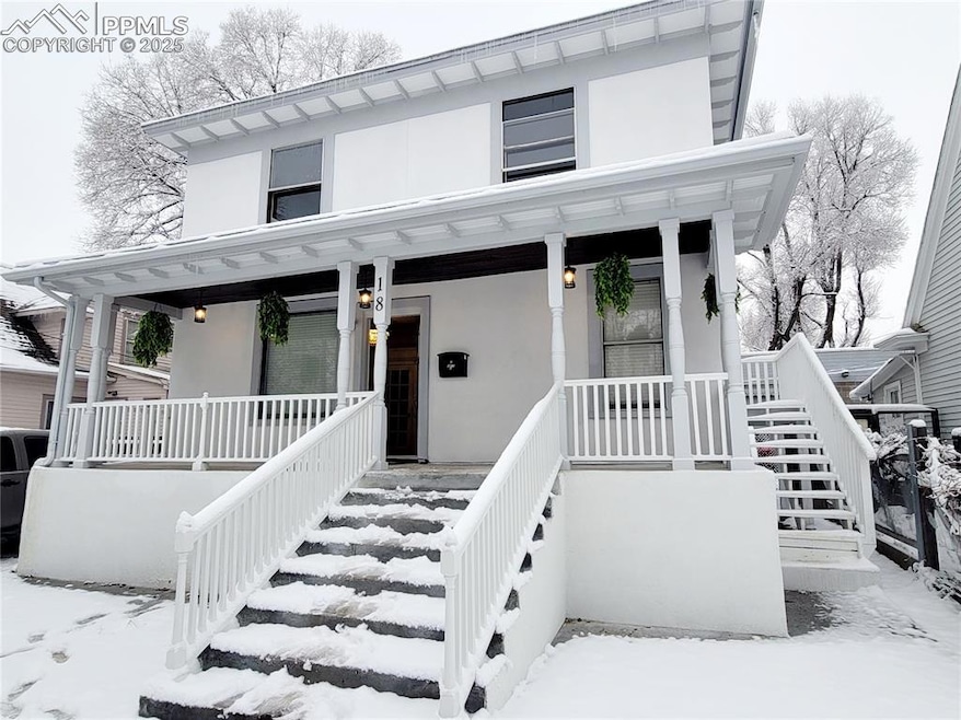 View of front of house with a porch, stairs, and stucco siding