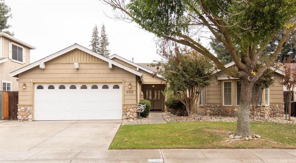 Welcome Home! Front of house featuring stone siding, double door entry and two car attached garage.