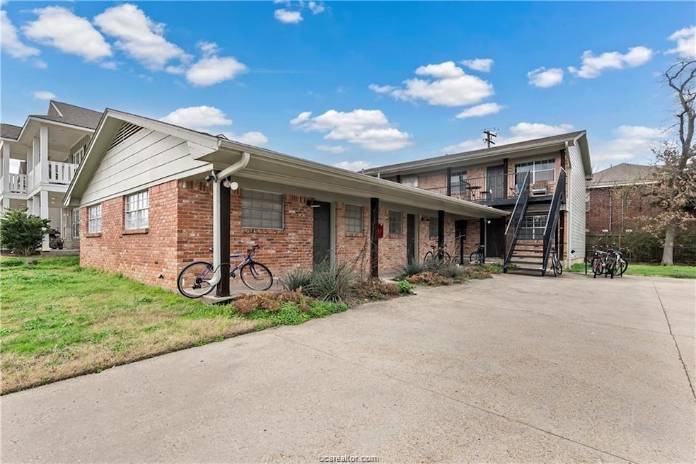 View of front of property with brick siding, concr