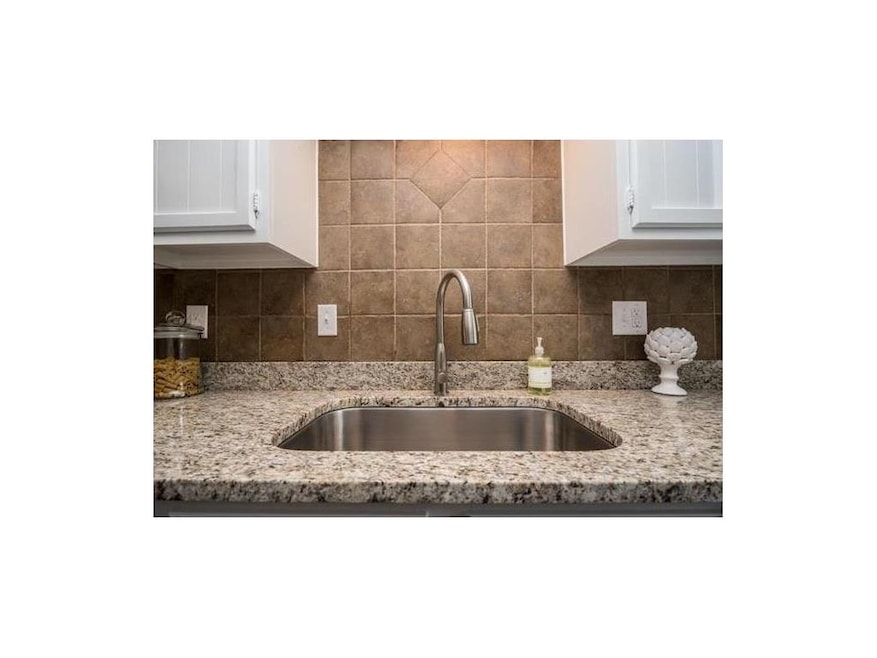 Kitchen features granite surfaces