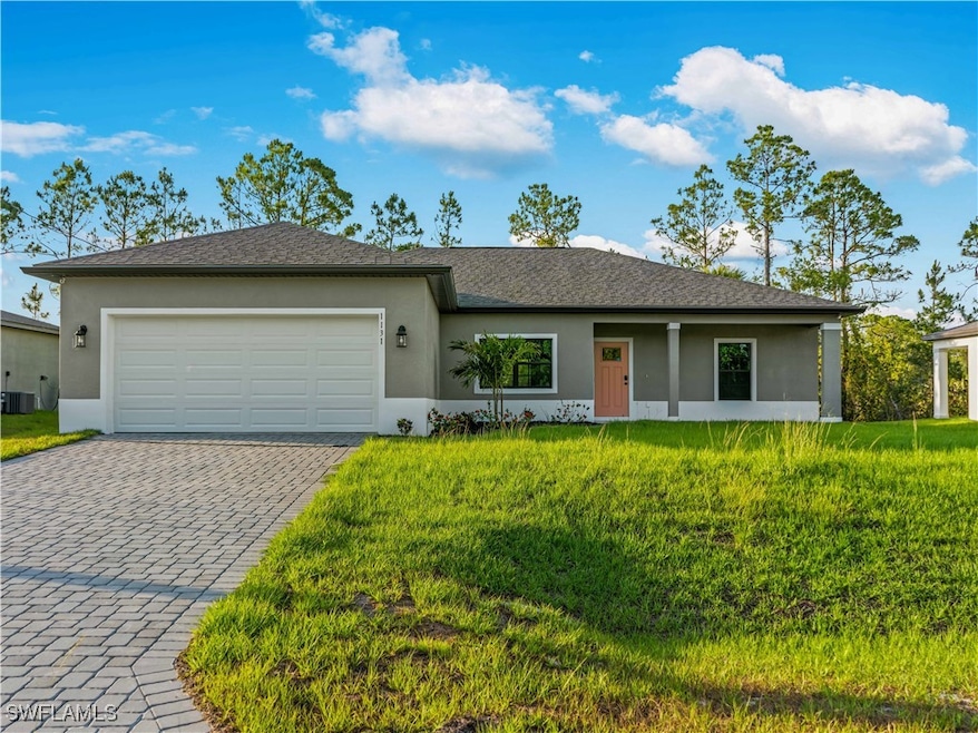 Ranch-style home featuring decorative driveway, a