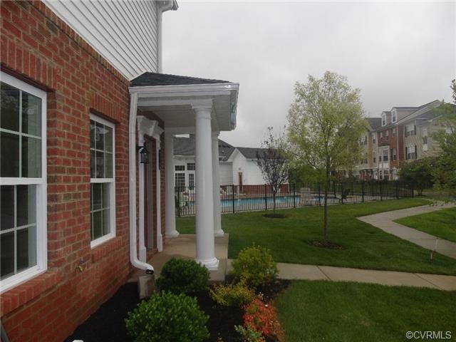 view of an end unit with a porch and delightful so