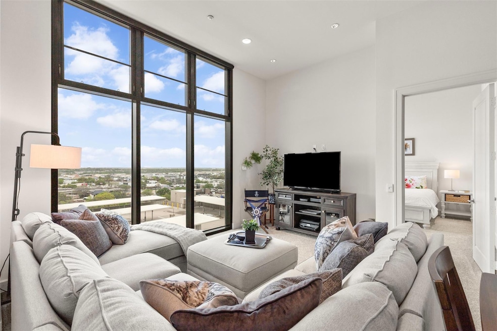 Living room featuring carpet, expansive windows, a