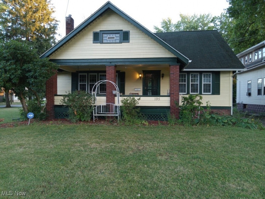 Bungalow-style house with a front lawn and a porch