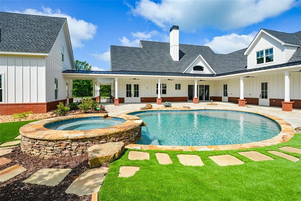 View of pool with a patio, an in ground hot tub, c