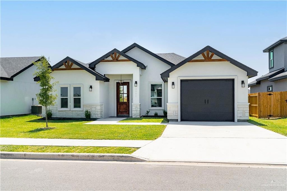 Modern farmhouse style home with an attached garage, concrete driveway, stone siding, and stucco siding