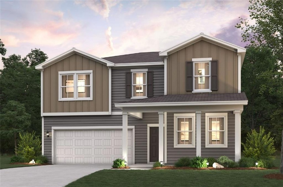 View of front of home featuring a garage and a law