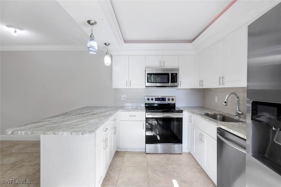 Kitchen with stainless steel appliances, a peninsu