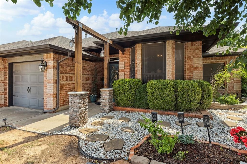 Ranch-style house featuring brick siding, a garage, roof with shingles, and driveway