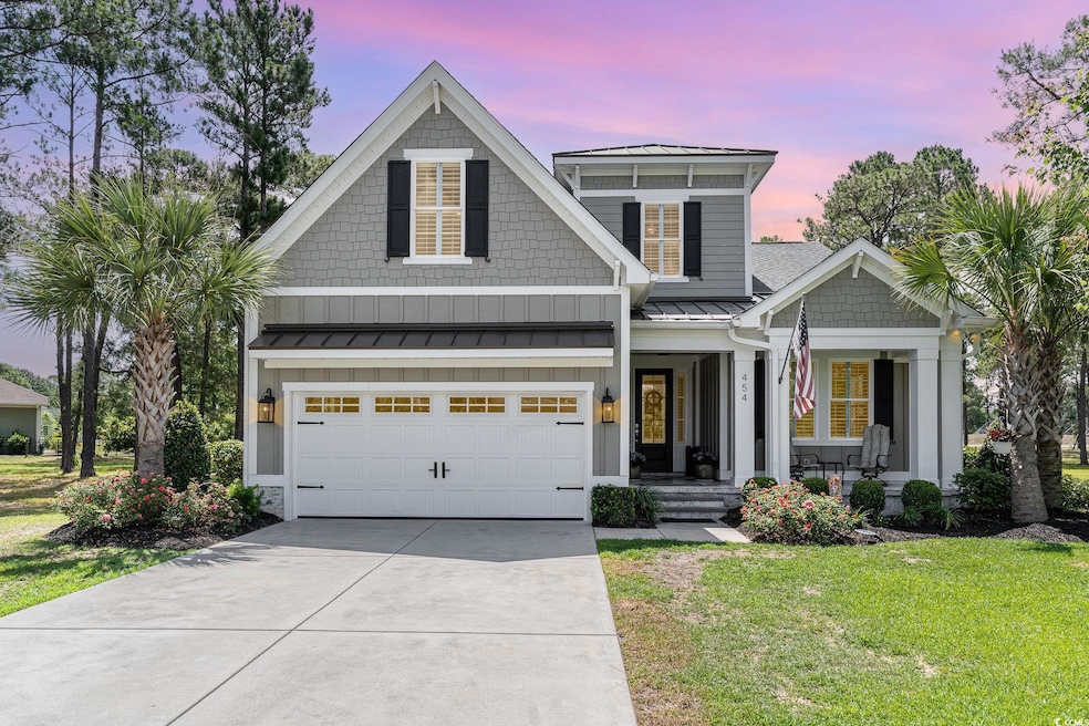 View of front facade featuring a garage, a porch, 