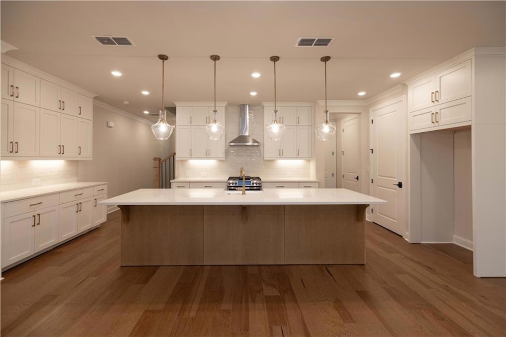 Kitchen featuring stainless steel gas stove, wall 