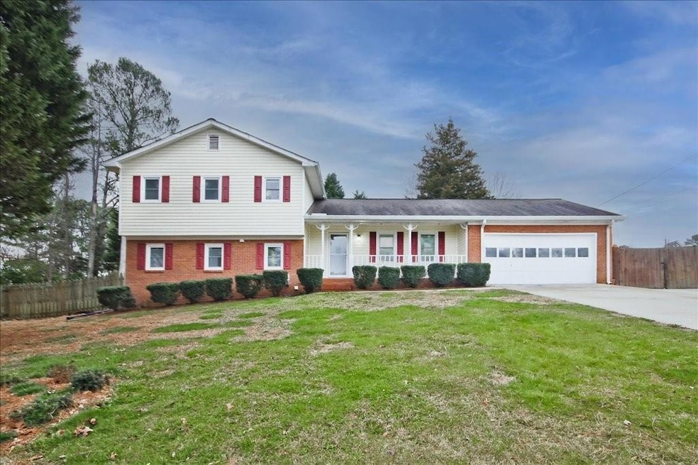 Split level home with a garage, a front yard, and 