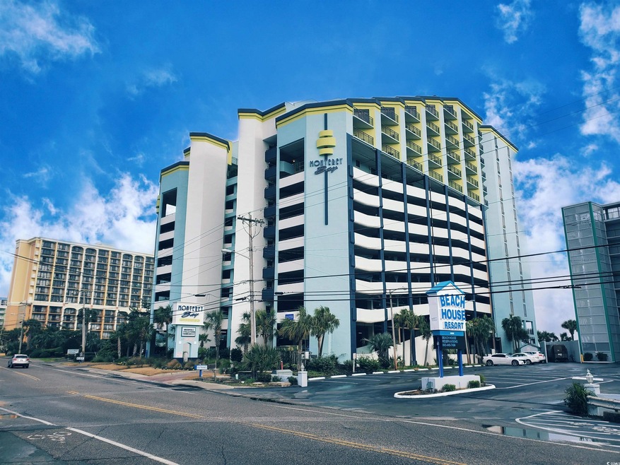 View of property featuring uncovered parking