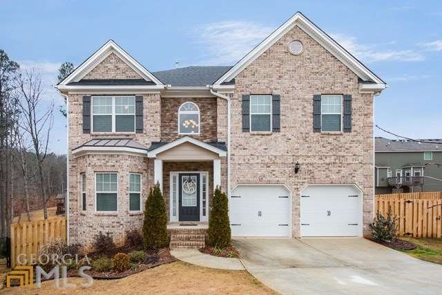 Front of home, fenced yard