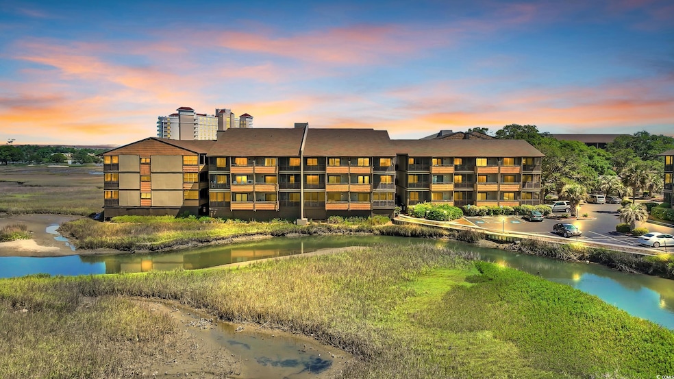 View of apartment building / complex with a water 