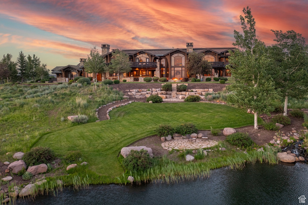 View of home's community featuring a lawn and a water view