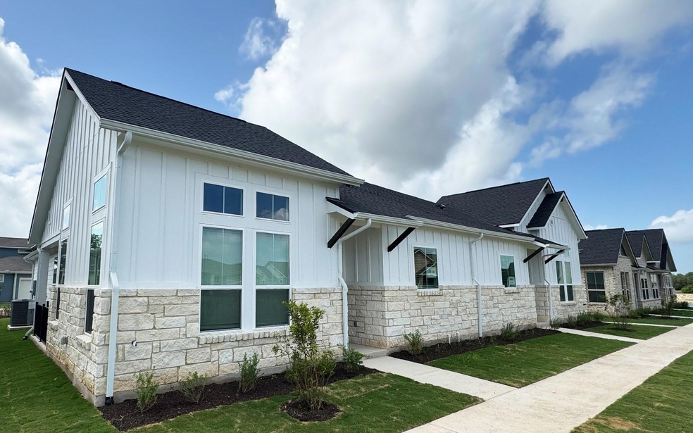 View of side of home with stone siding, board and