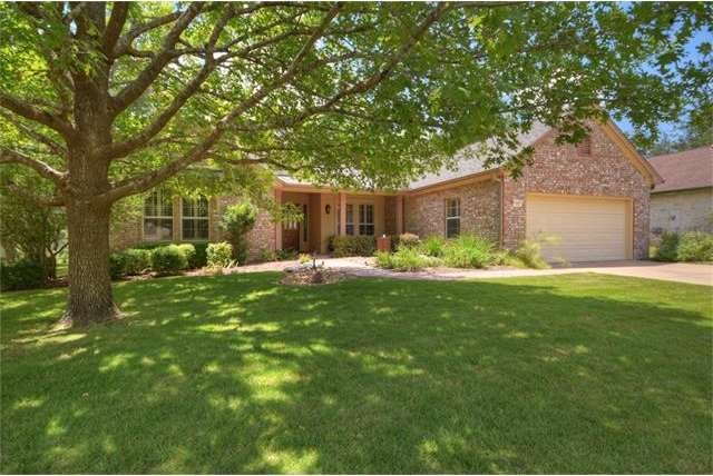 A shaded front yard and golf course/greenbelt back
