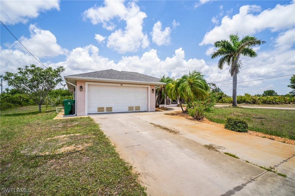 View of front facade featuring driveway, stucco si