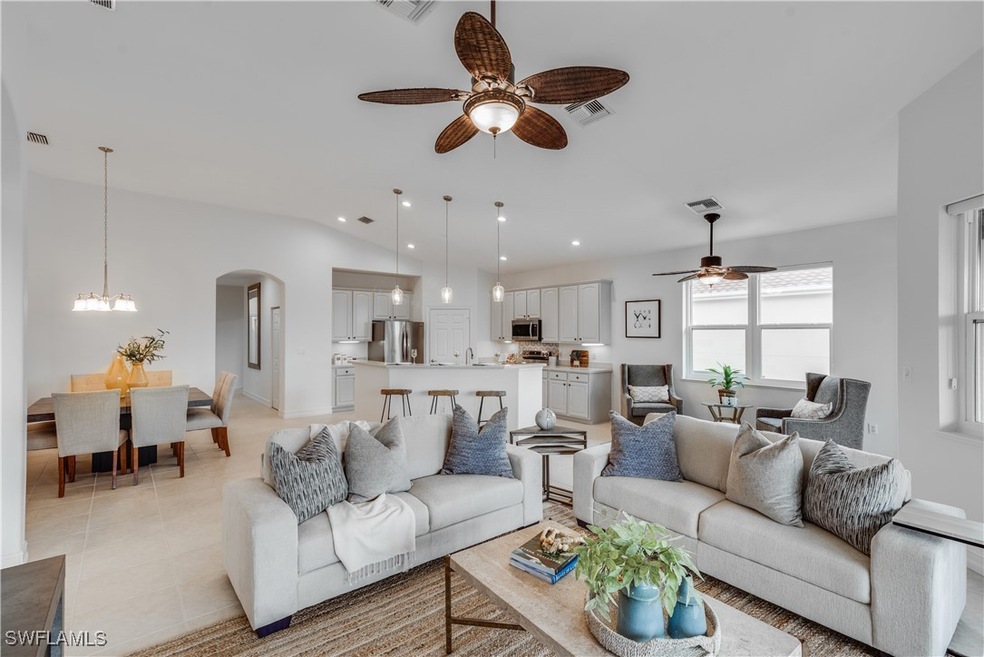 Living room featuring ceiling fan with notable cha